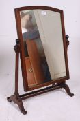 A Victorian mahogany toilet swing mirror raised on turned supports with twin spindle stretchers.