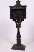 A large cast iron exterior floor mountable letter box.
