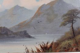 A 19th century oil on board painting of a lake scene set within a good gilt wood frame
