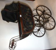 A 20th century decorative wooden and cast iron pram.