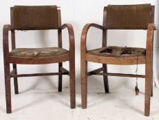 A pair of mid 20th century oak bentwood armchairs raised on squared supports with drop in seats.
