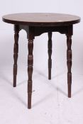 A 20th century oak circular tavern table raised on turned and tapered angled supports.