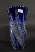 A large blue decorative cut glass vase, with relief etched detail to all borders.