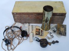 A vintage trunk containing a collection of military items to include a pair of RFC collar badges,