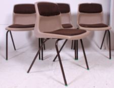 Four Vintage stacking chairs with padded backs and seats.