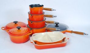 An excellent collection of new and un-used Le Crueset cooking wares in orange to include dishes,