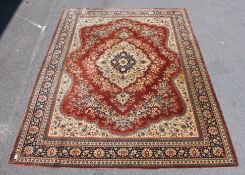 A large 20th century Persian style rug having blond out ground with medallions to centre