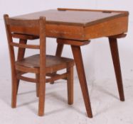 A good retro mid 20th century childrens wooden desk together with a similar childrens desk chair