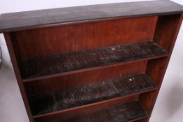 A large open window early 20th century bookcase cabinet having plinth base with fixed shelves and