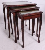 An antique style mahogany and leather graduating nest of tables.