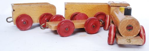 A vintage Chad Valley early 20th century wooden childs toy train with rolling stock.