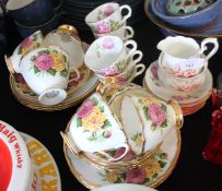 Two chintzy floral part china tea services the first by Imperial china and the other by Clarance