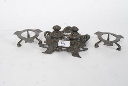 An Art Nouveau pewter desk inkwell together with a pair of Liberty style salt spoons