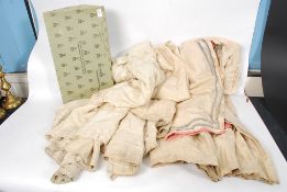 A collection of Edwardian skirts and under skirts along with a vintage Harvey Nicholls box.