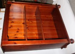 A 20th century pine bookcase cabinet with two shelves to interior, standing on bun feet.