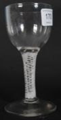 A late 18th / early 19th century wine glass with funnel shaped bowl raised on white spiralling