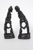 A pair of good Indonesian 20th century carved horn erotic figures raised on square plinths