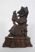 A large and heavy cast iron door stop / doorstop in the form of Mr Punch