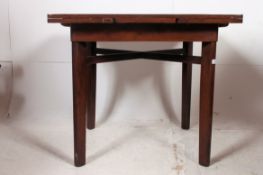 A 1930's oak draw leaf refectory dining table of square form raised on squared corner legs with