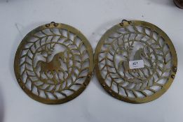 A pair of 19th century pierced trivets / roundels with horses to centre being converted to hang as