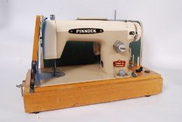 A mid century Australian made cased electric sewing machine by Pinnock