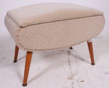 A good 1950's retro vintage upholstered sewing box ottoman being raised on turned supports with
