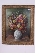 A 20th century oil on board painting of a floral vase, within a decorative frame.