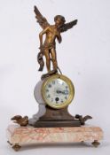 A 19th century French rouge veined marble mantel clock with bronze sculptured figure above.