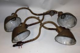 A collection of 4x vintage retro industrial work lights on angled supports,