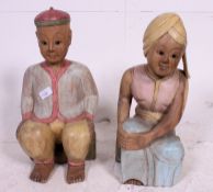 A pair of decorative Balinese painted carved woodenware figures of a male and female couple