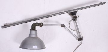A vintage 20th century anglepoise lamp raised on a terraced base with pendant shade