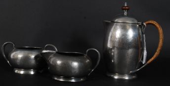 A Liberty pewter three piece tea / coffee set, with hammered finish,