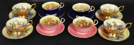 A collection of decorative 20th century Aynsley trios / cups and plates in gilded two tone,