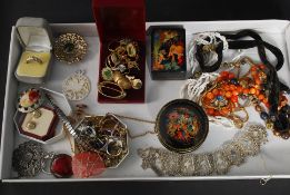 A collection of costume jewellery to include necklaces, pendants, enamel badges,