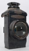 A vintage 20th century ebonised railway lantern bearing notation atop with handle