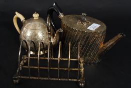 A good early 20th century teapot together with another and a large silver plated toast rack of