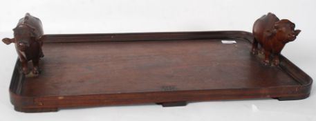 An Edwardian oak butlers tray, the handles in the form of bullocks.