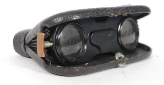 A vintage 20th century pair of Zingraf folding opera glasses set within the folding leatherette