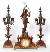 A fantastic 19th century rouge marble mantel clock and candelabra garnitures.
