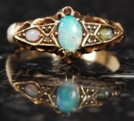 An 18ct gold antique opal ring, with heavily decorated shoulders and large opal to centre.