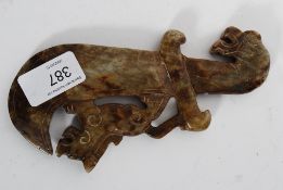 A decorative well carved marble Dragon resting on a sword