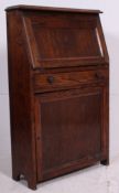 A 20th century oak students bureau with fall front desk top and shelves beneath