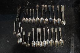 A collection of flatwares to include 4 silver hallmarked Walker & Hall spoons,