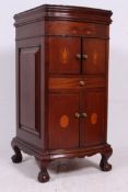An Edwardian mahogany inlaid bow front gramaphone cabinet raised on ball and claw feet having twin