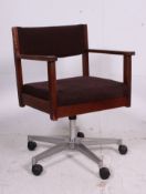 A vintage 1970's Industrial School teak and velour upholstered teachers swivel chair.
