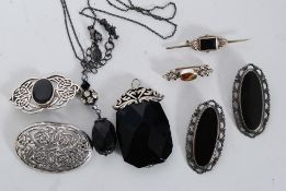 A collection of vintage silver mourning jewellery to including brooches, pendant,