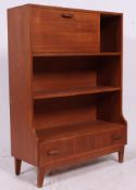A retro 1970's teak Danish style student bureau having fall front desk with bookcases above