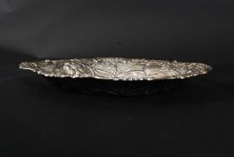 A Victorian large silver hallmarked rococo bon bon dish of oval form being hammered in relief with