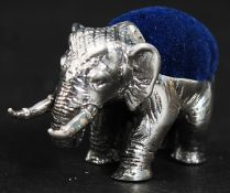A 20th century silver elephant pin cushion with blue baize cushion. Measures: 15g.