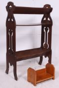 A 20th century oak Arts & Crafts three tier book trough with pierced end supports having troughs to